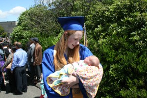 The graduate holding her baby sister